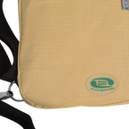 Close-up of the Hajj Safe logo badge on the beige Hajj bag for men