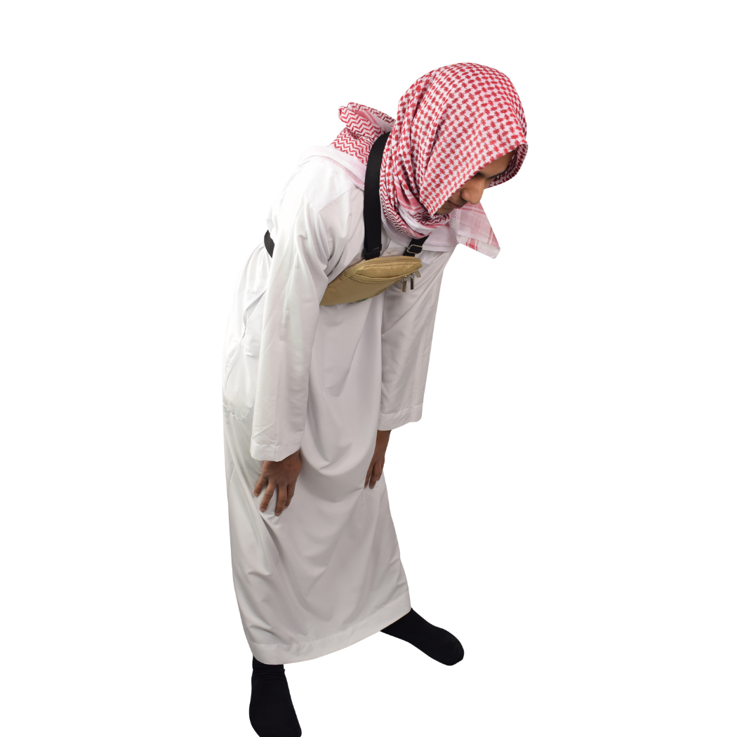 A man bowing in prayer wearing the beige Hajj bag for men on his chest