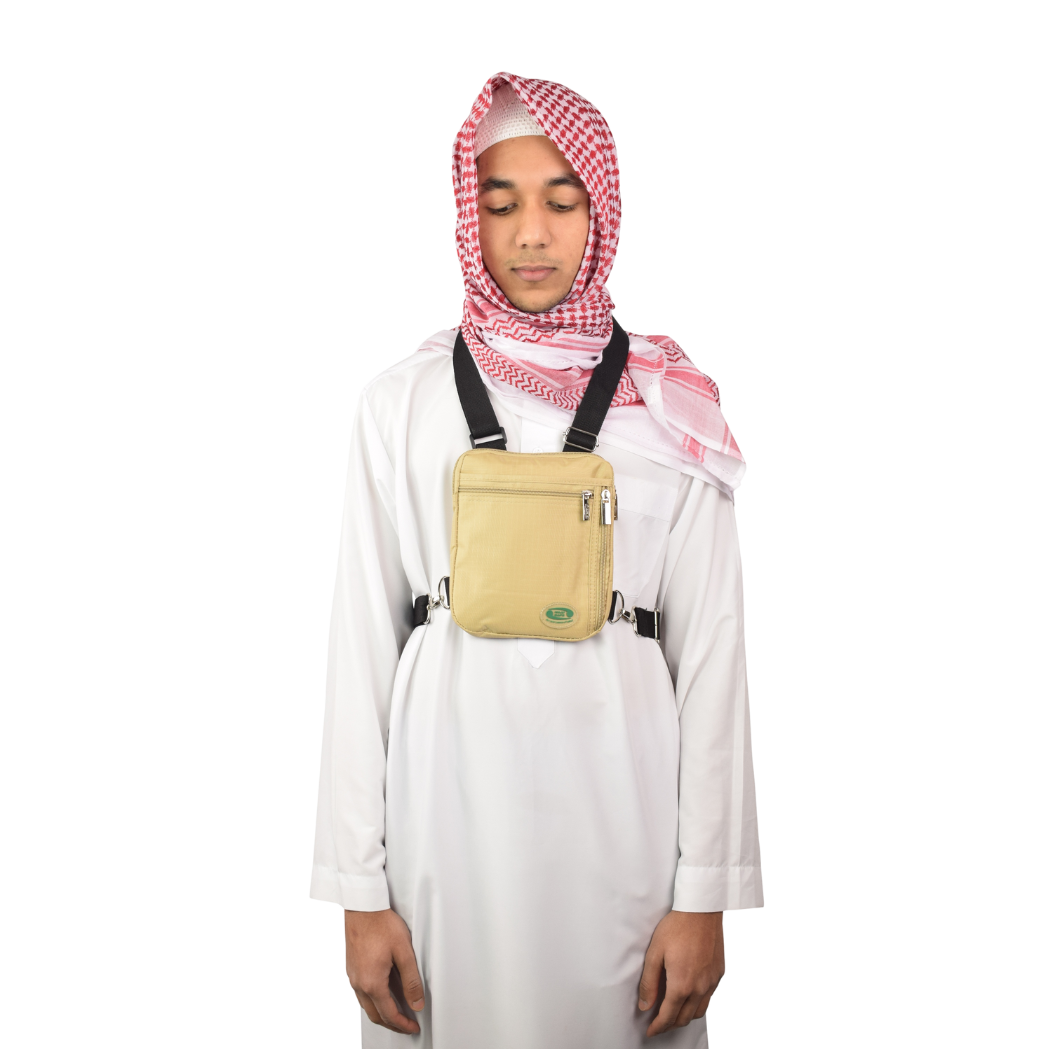 A man in a white thobe wears the beige Hajj bag for men on his chest
