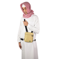 A man in a white thobe and red-checked scarf wearing the beige Hajj bag for men