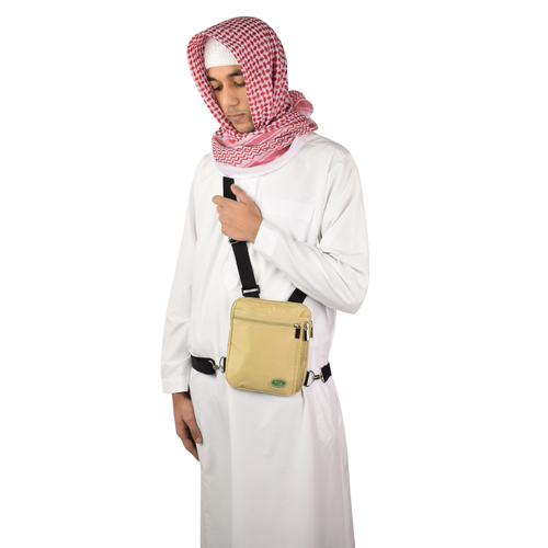 Beige Hajj and Umrah bag for men worn as a side bag
