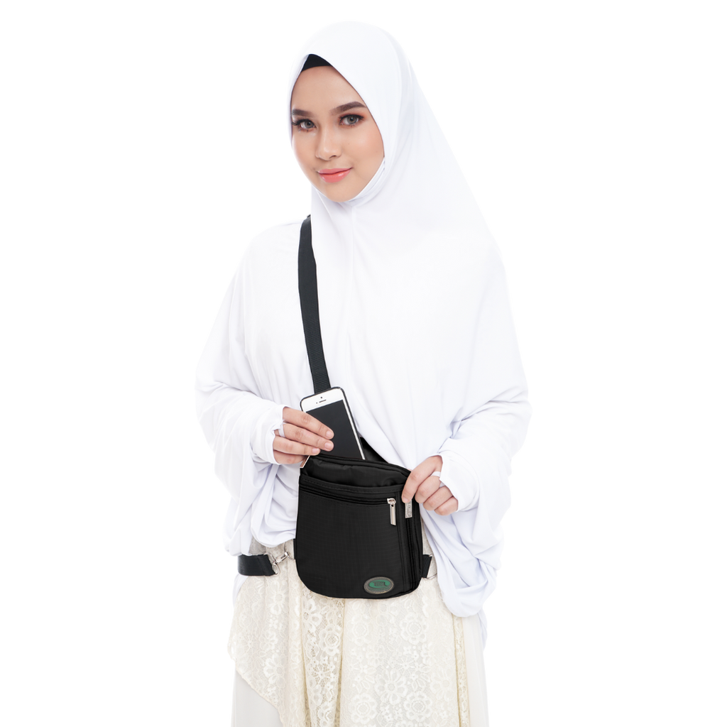 Woman carrying black Hajj and Umrah travel bag for pilgrimage