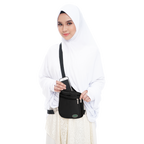 Woman carrying black Hajj and Umrah travel bag for pilgrimage